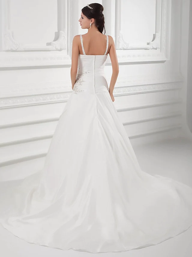 Close-up of the ruched bodice and beading on an A-line bridal dress.