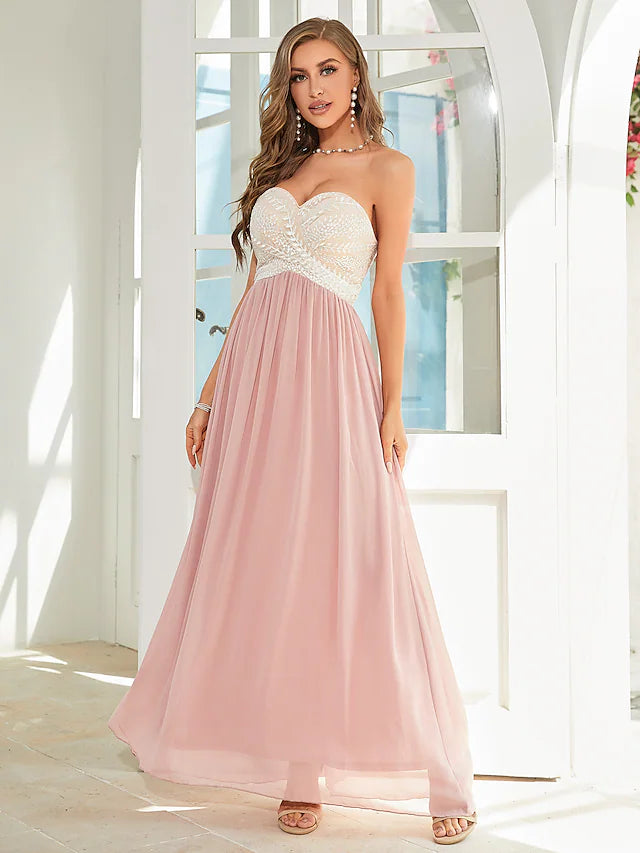 Back view of an A-line strapless floral applique chiffon dress.