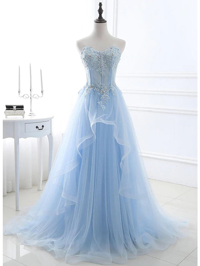 Full view of an elegant A-line strapless floral lace dress with a sweep train.