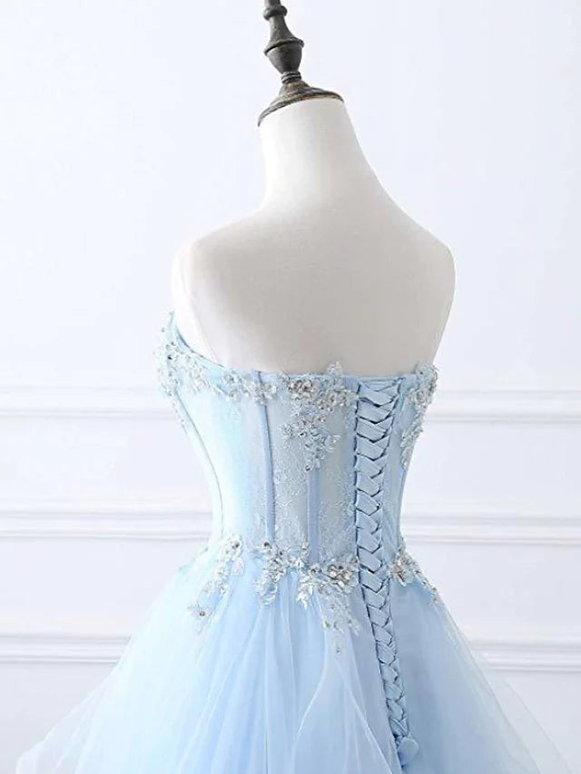 Model posing in the A-line strapless prom dress, emphasizing its full silhouette and elegant design.