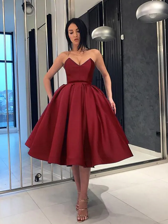 Minimalist knee-length satin dress, front view.