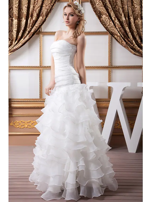 Close-up of the ruched organza and satin fabric on the wedding dress.