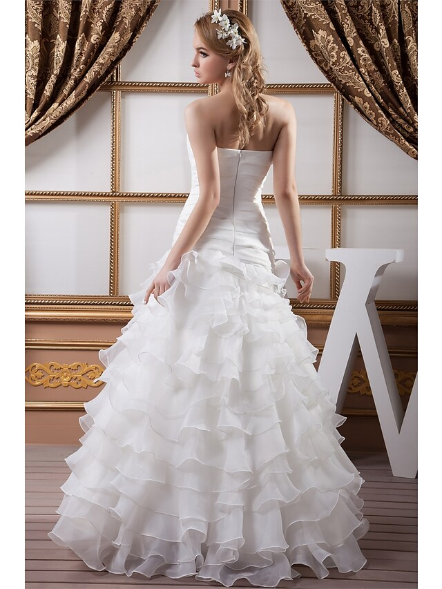 Side view of the elegant A-Line wedding gown.