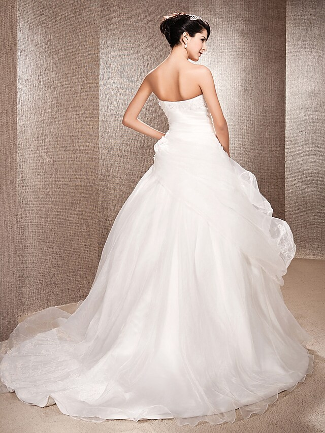Side view of the graceful strapless A-line wedding dress.