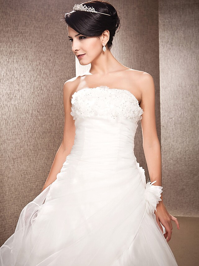 Model posing in the A-line wedding gown, highlighting its elegant silhouette.