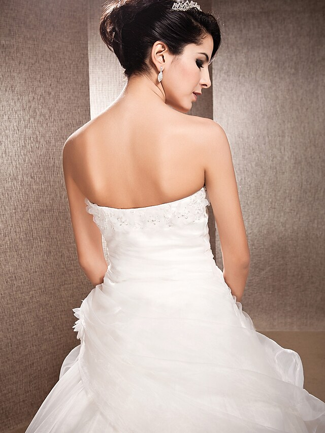 Detailed view of the luxurious organza skirt and extended train.