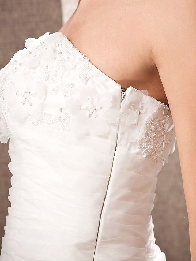 Elegant strapless wedding dress with a long train displayed beautifully.