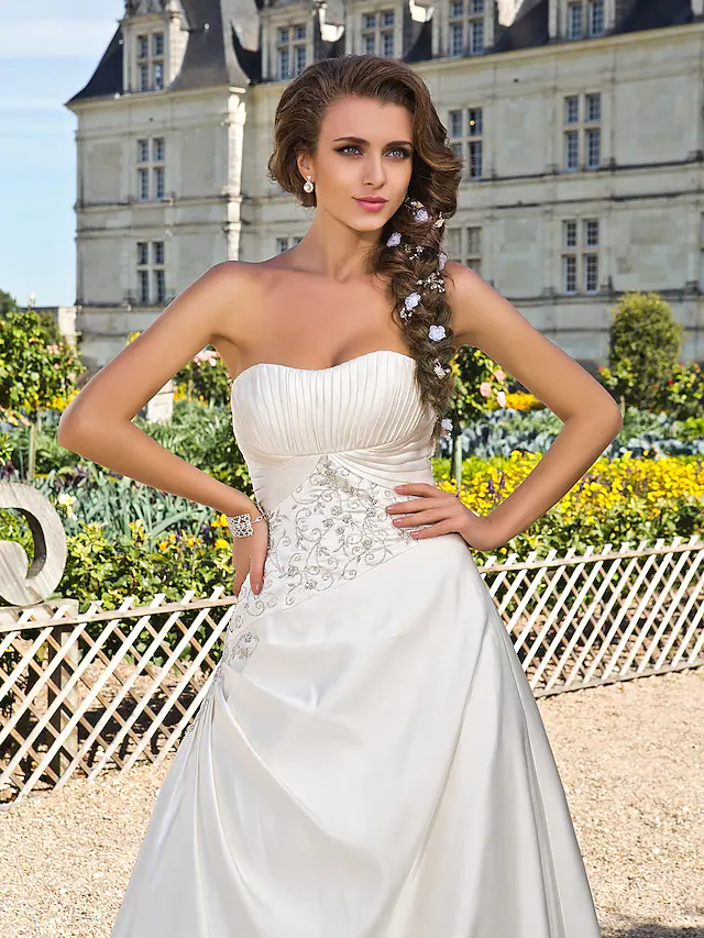 Elegant A-line strapless satin wedding dress with chapel train.