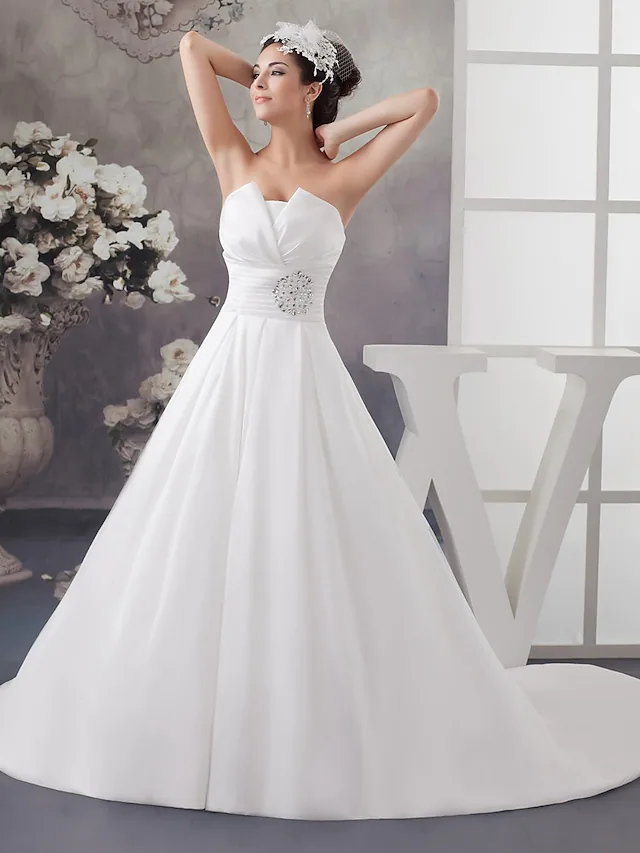 Elegant A-Line strapless wedding dress with ruched satin bodice and chapel train.