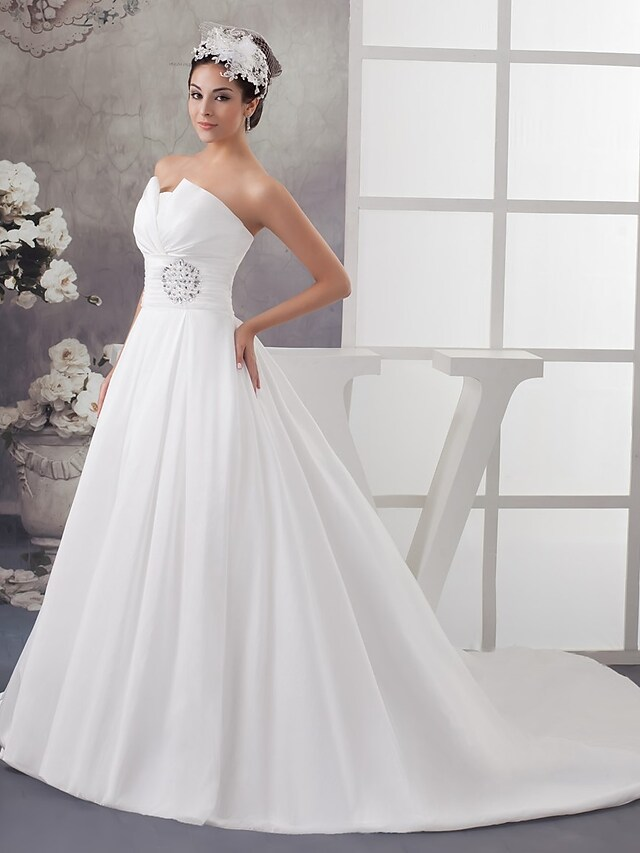 Back view of A-Line wedding dress showing chapel train and draping details.