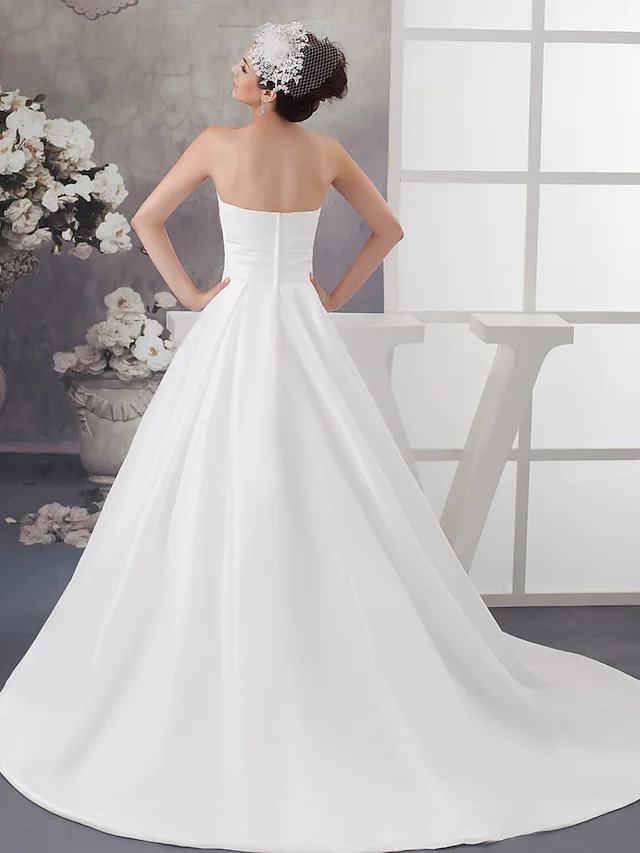 Side profile of strapless A-Line wedding gown with beading on bodice.