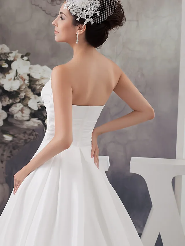 Full length view of A-Line bridal gown with flowing chapel train.