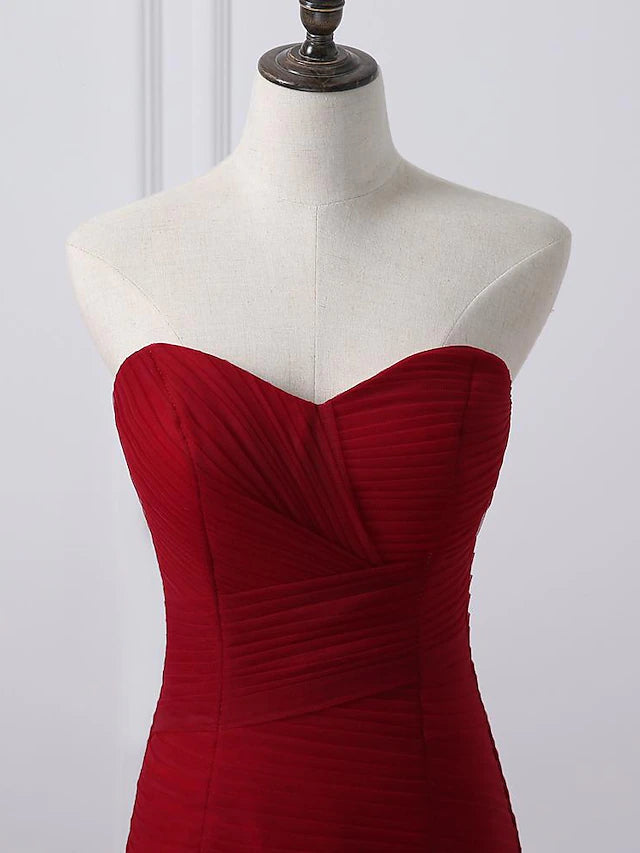 Back view of a plus size A-line wedding dress showing the chapel train and ruched details.