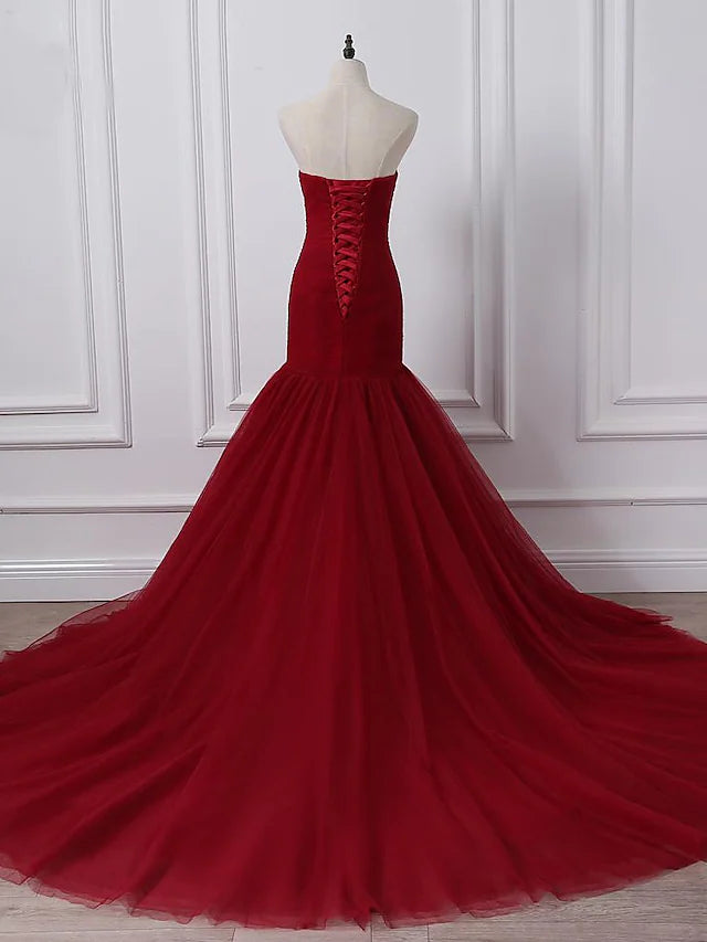 Close-up of the ruched bodice and strapless neckline on a plus size wedding dress.