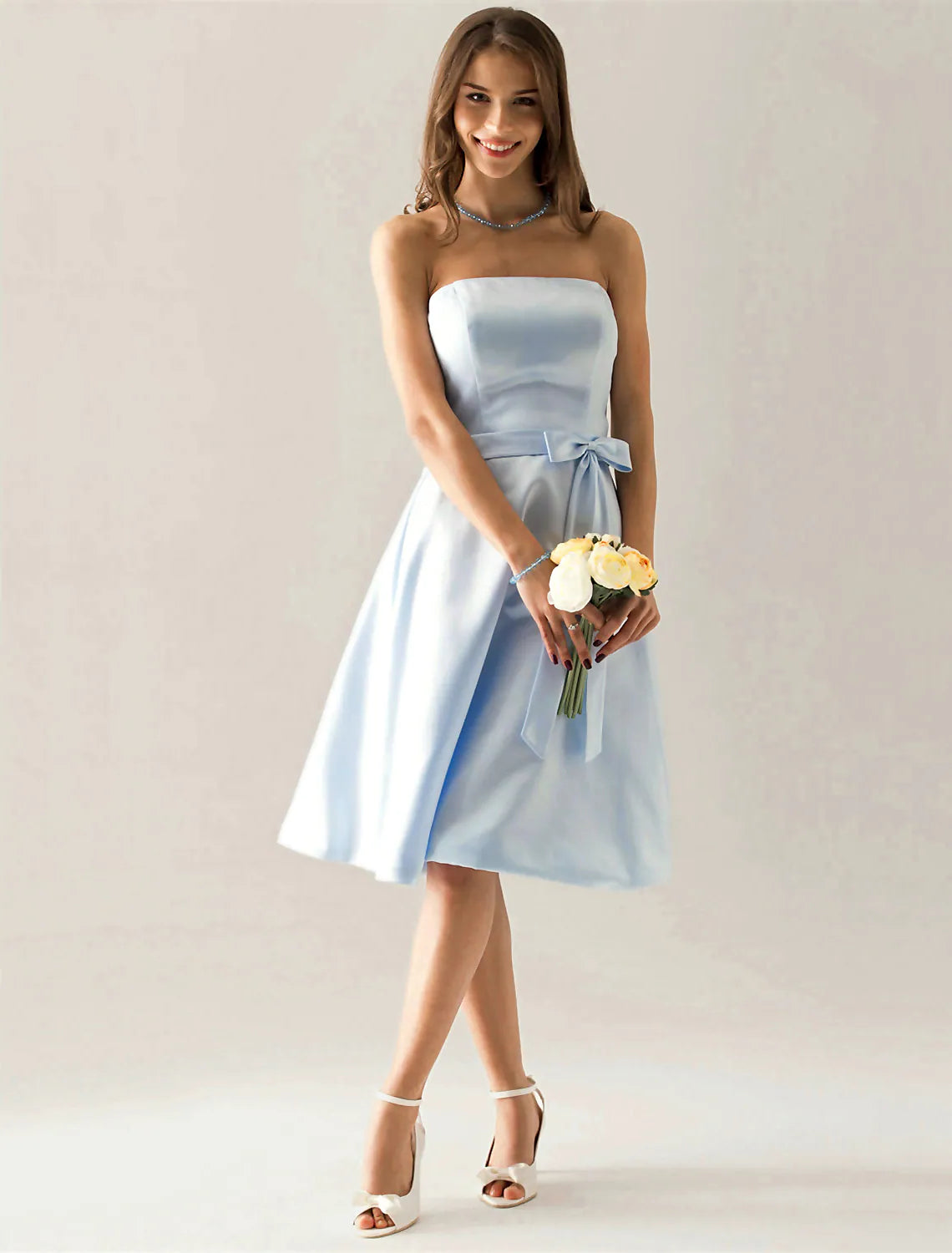 Close-up of the satin fabric and sash detail on the A-line bridesmaid dress.