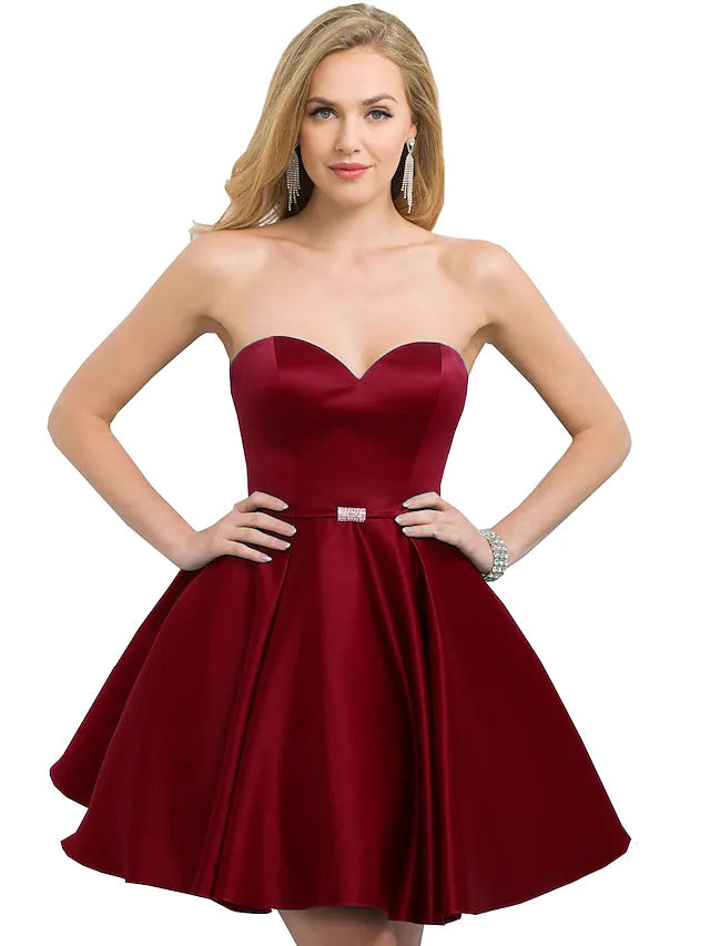 Model in an elegant A-line strapless satin cocktail dress.