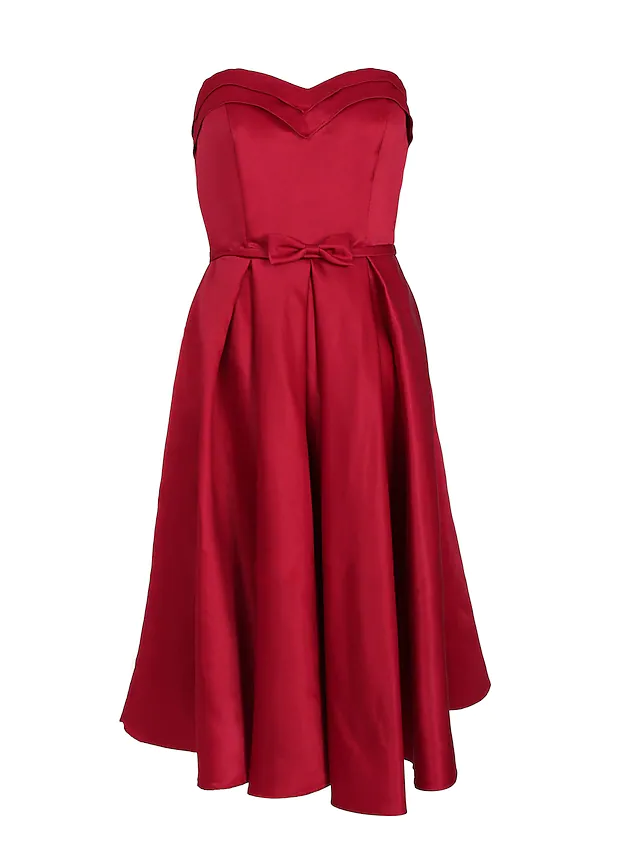 Close-up of the bow and pleat details on the satin dress.