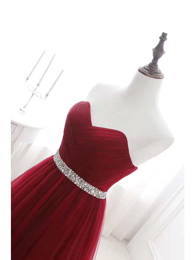 Close-up of the crystal embellishments on the bodice of the satin dress.