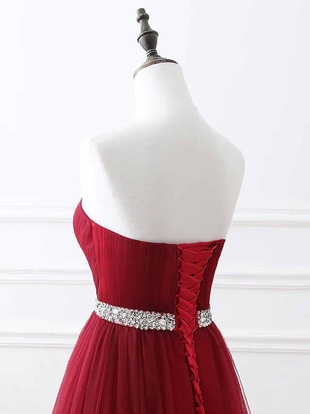 Detail of the luxurious satin fabric and the flowing skirt of the formal dress.