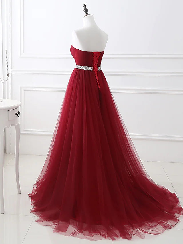 Full length view of the formal strapless A-line dress.