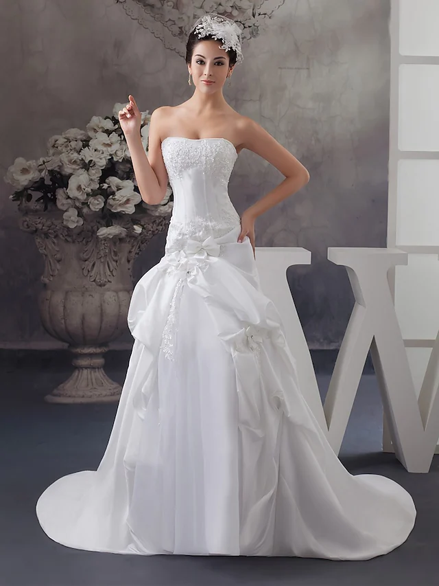 Elegant A-Line strapless satin wedding dress with beading.