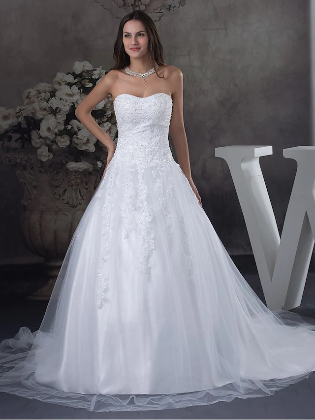 Front view of an A-line strapless sweetheart wedding dress with lace and beading.