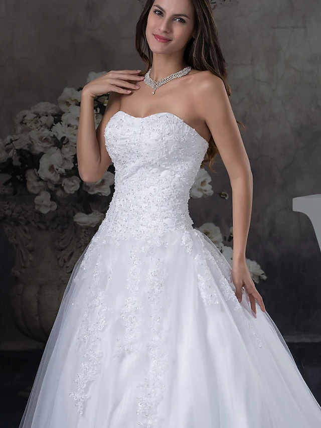 Back view of an A-line wedding dress with a flowing court train.