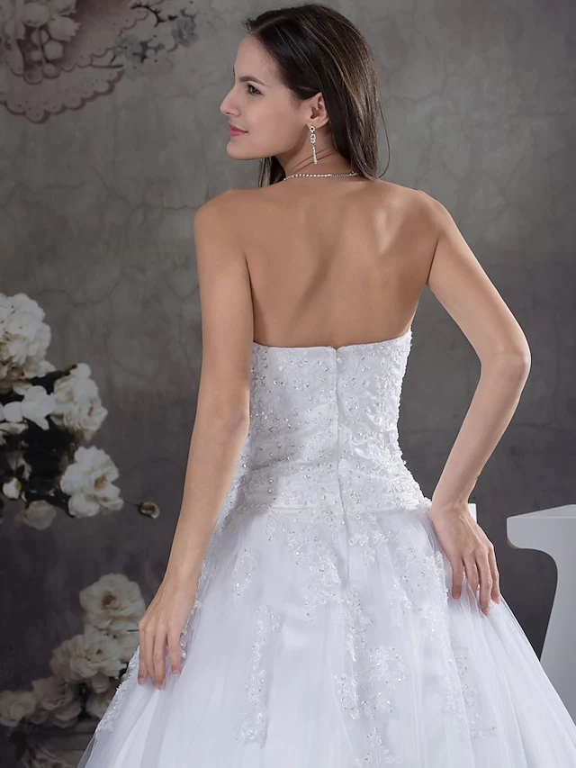 Detailed view of the strapless sweetheart neckline and bodice of the wedding gown.
