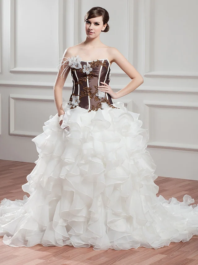 Front view of an A-Line strapless wedding dress with beading and ruffles.
