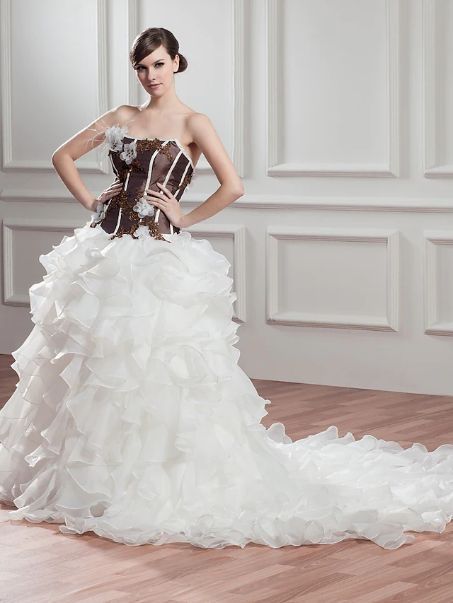 Side view of the A-Line wedding dress, showcasing the chapel train and ruffles.