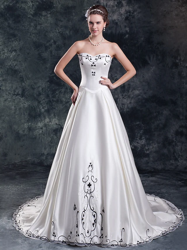 Elegant A-Line strapless wedding dress with embroidery.