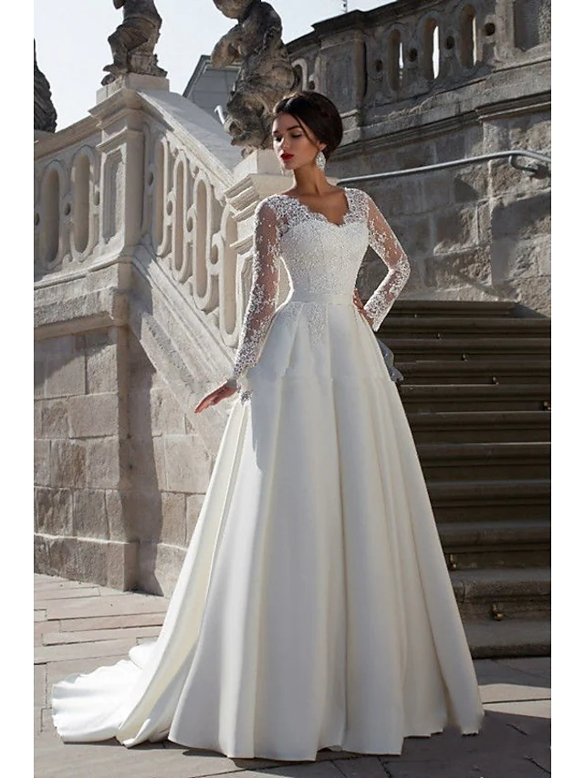 Elegant A-line strapless wedding dress with lace appliques and a court train.