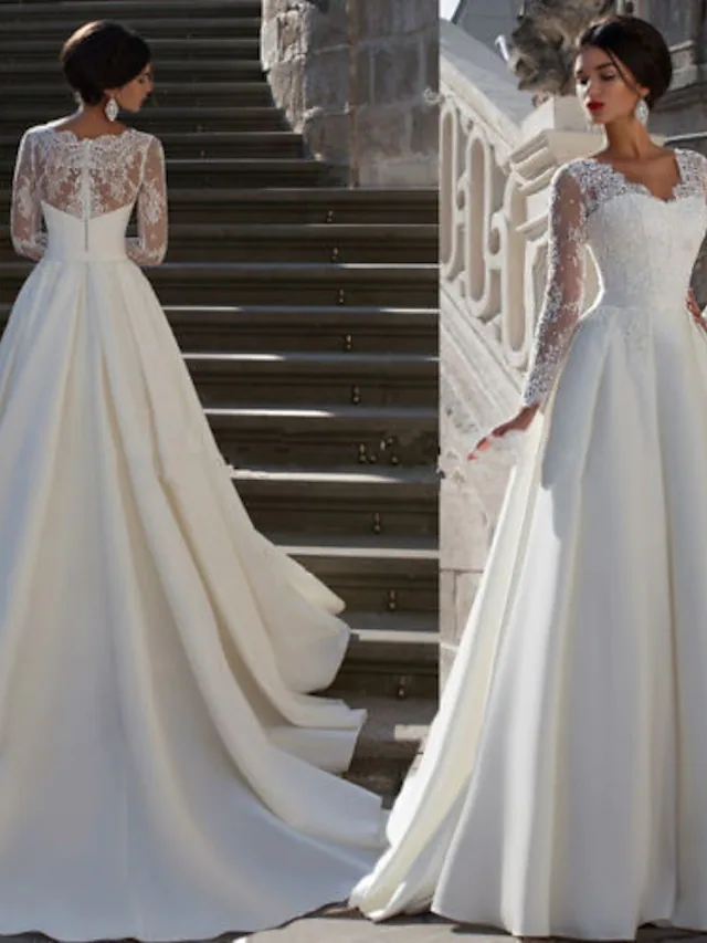 Side profile of a strapless A-line wedding dress with delicate appliques.