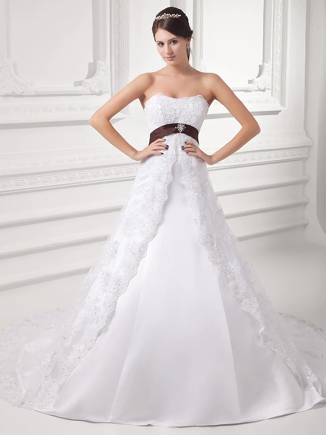 Elegant A-Line strapless wedding dress with lace and tulle chapel train.