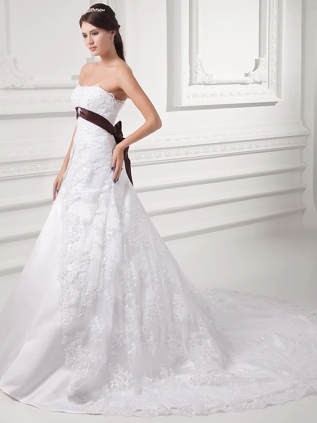 Back view of A-Line wedding dress showing chapel train and delicate beading.