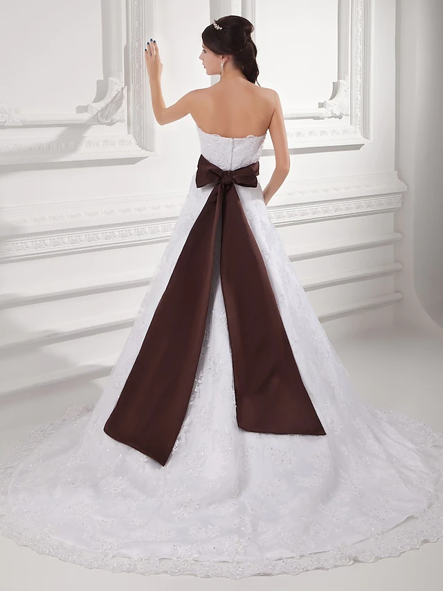 Side view of the elegant A-Line bridal gown with flowing tulle fabric.