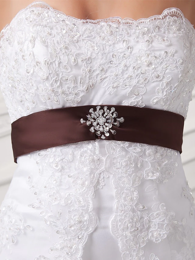 Detail of a decorative bow and ribbon embellishment on the wedding dress.