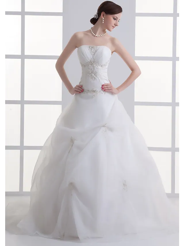 A-Line strapless wedding dress with ruched bodice and beading.