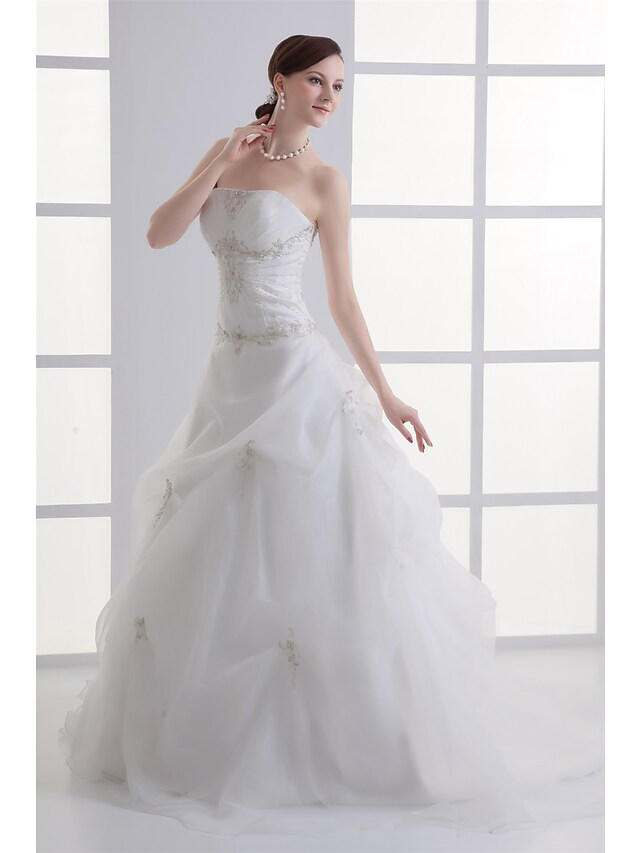 Back view of A-Line wedding dress showing court train and pick-up skirt.