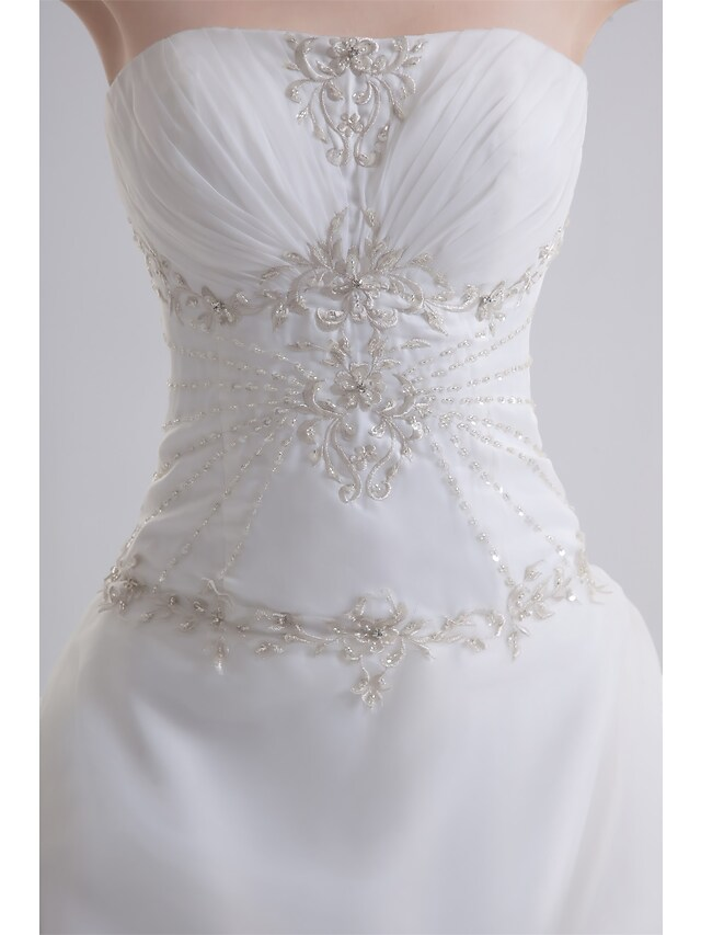 Side view of elegant A-Line wedding dress with flowing court train.