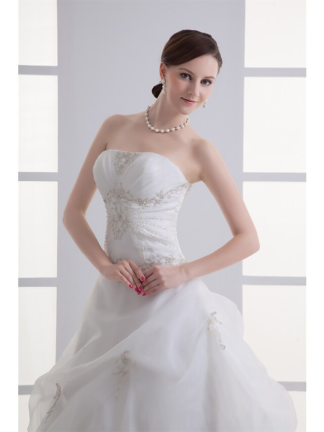 Full length view of A-Line bridal gown in organza and satin.