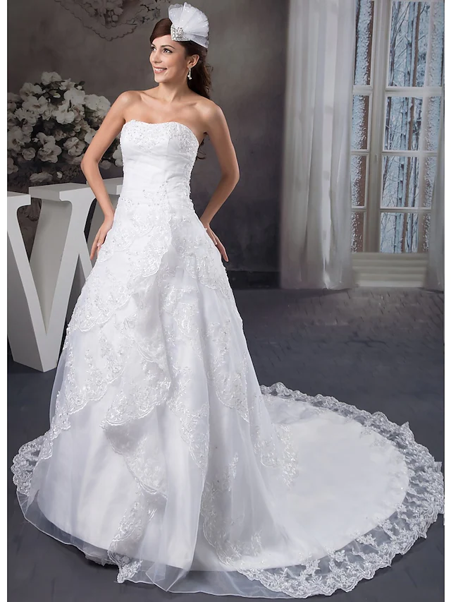 Back view of A-Line wedding gown showing chapel train and zipper closure.
