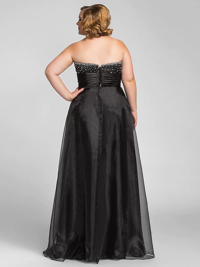 Full view of a model wearing the A-line black organza formal dress.