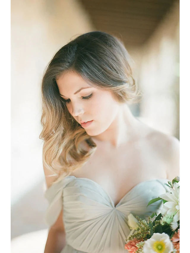 Side view of a floor length A-line bridesmaid dress.