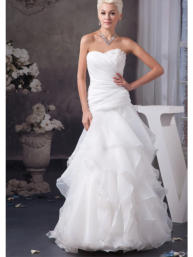 A-Line wedding dress with sweetheart neckline and cascading ruffles.