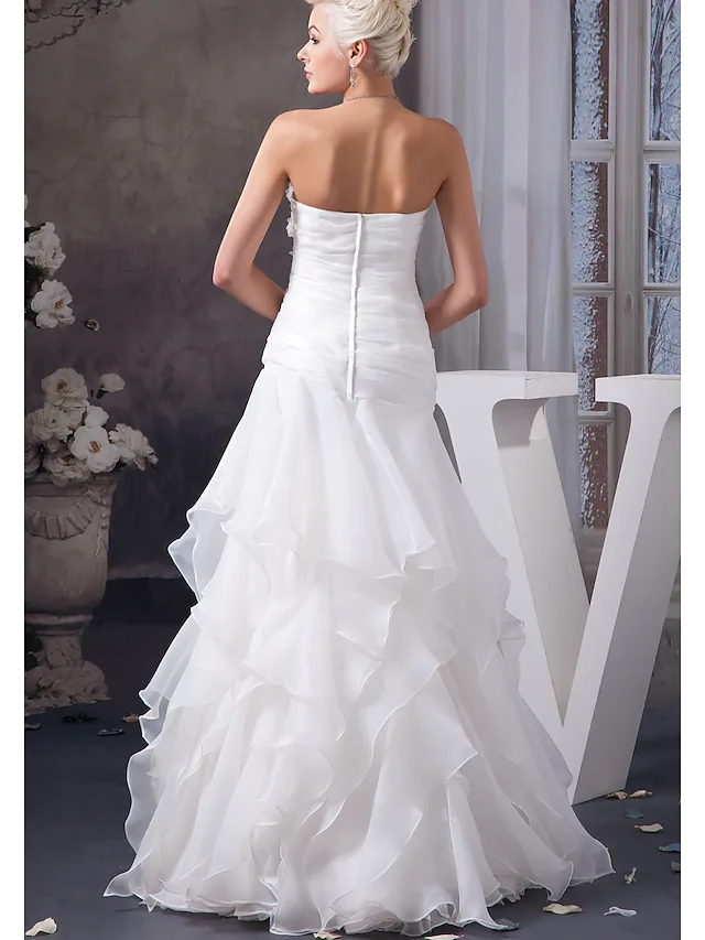 Side view of strapless A-Line wedding gown with lace details.