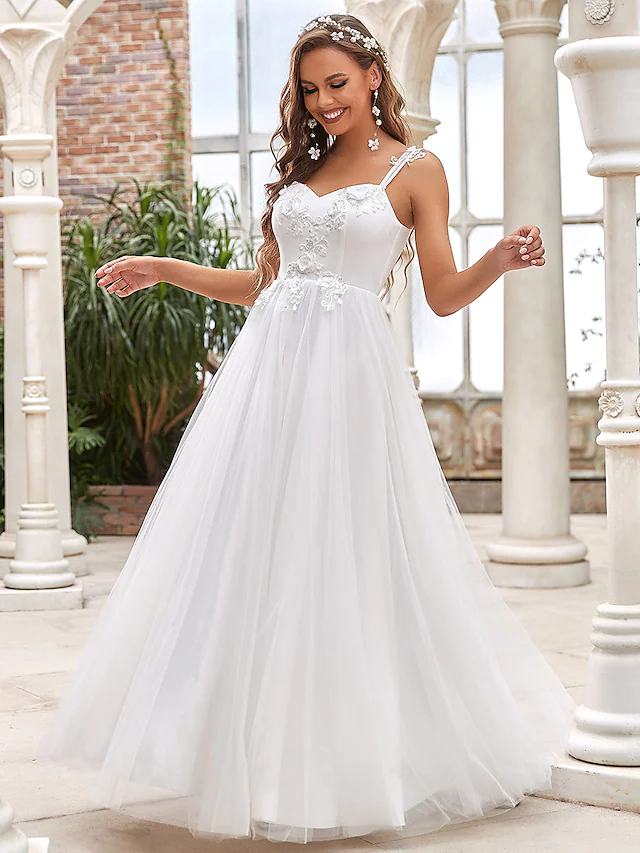 Close-up of lace and tulle fabric with appliques on an A-Line wedding gown.