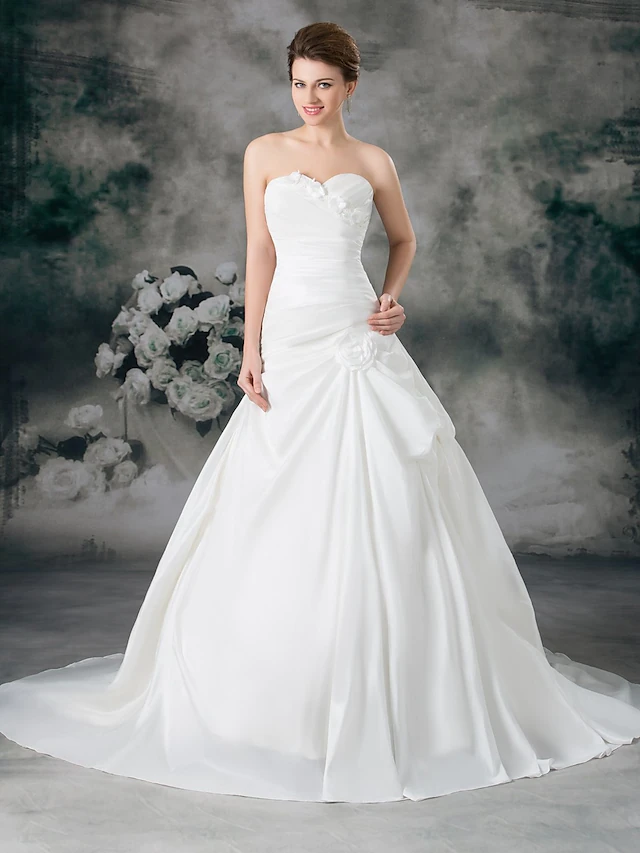 Elegant A-line wedding dress with sweetheart neckline and ruched bodice.