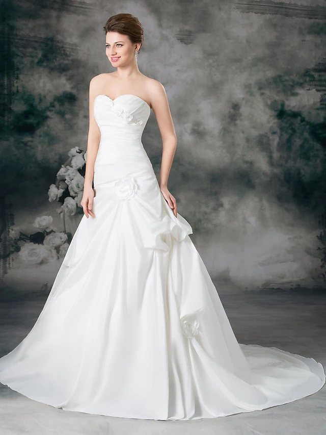 Back view of A-line wedding dress showing court train and side-draped detail.