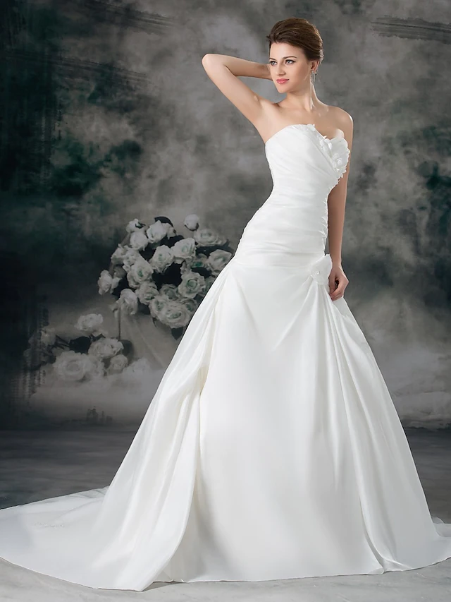 Close-up of sweetheart neckline and ruched detailing on wedding gown.